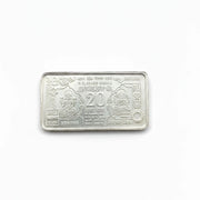 Silver bar with Ganesh and Laxmi idols on a silver background