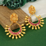 Load image into Gallery viewer, A pair of gold-plated silver earrings with red stone inlays, displayed on a wooden surface with a floral background.
