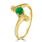 Minimal gold-plated ring with green gemstone – close-up design shot
