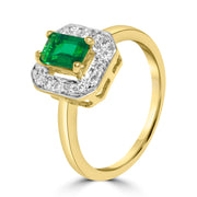 Gold ring with a green gemstone and diamond accents 